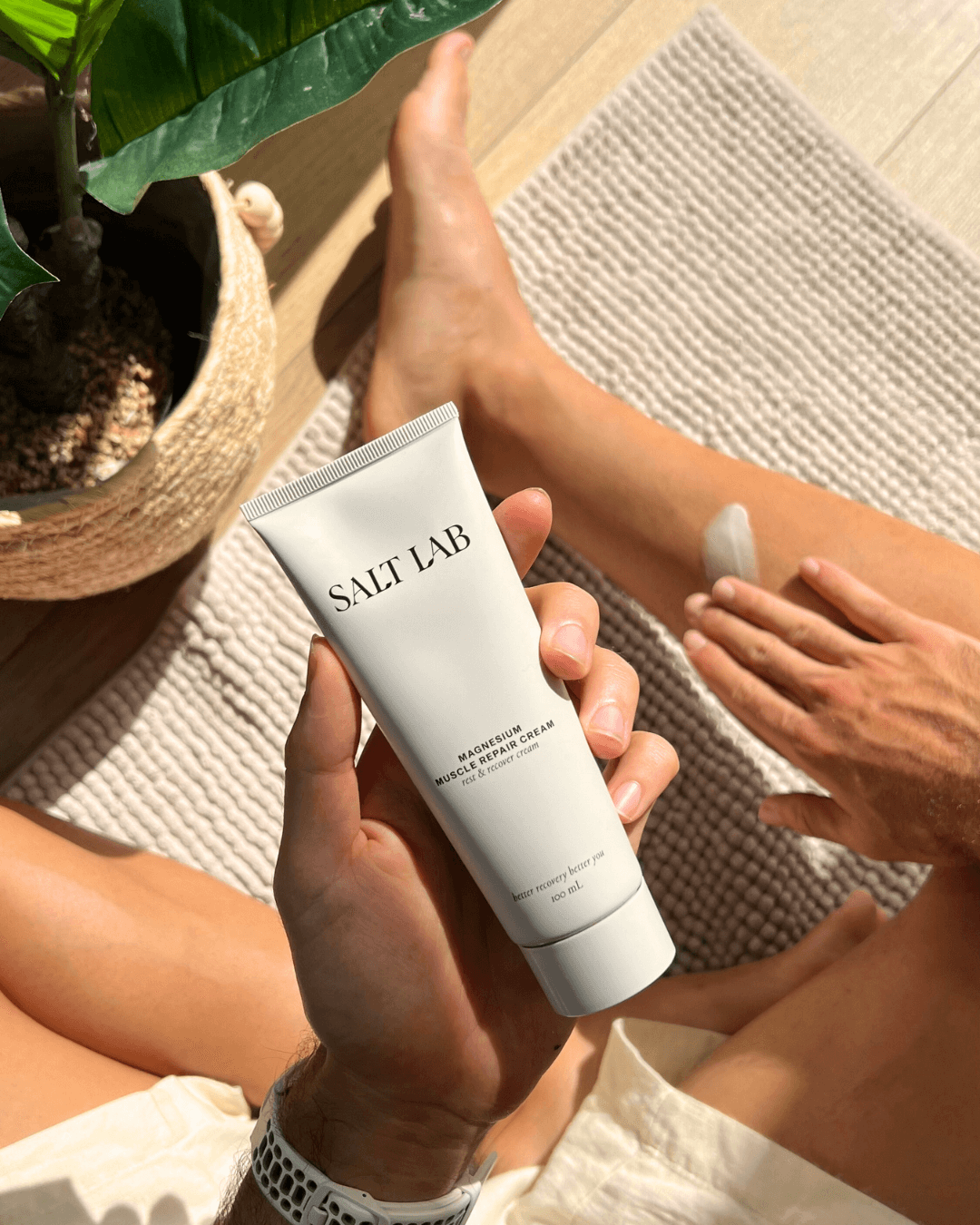 Applying Salt Lab Magnesium Muscle Repair Cream on leg